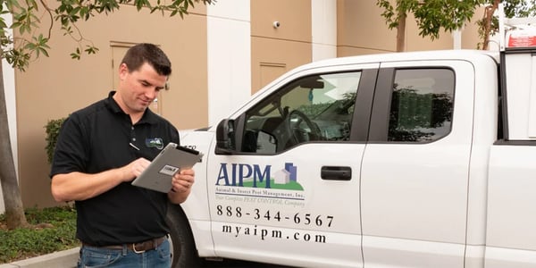 Paul Townsend in front of AIPM truck taking notes on ipad